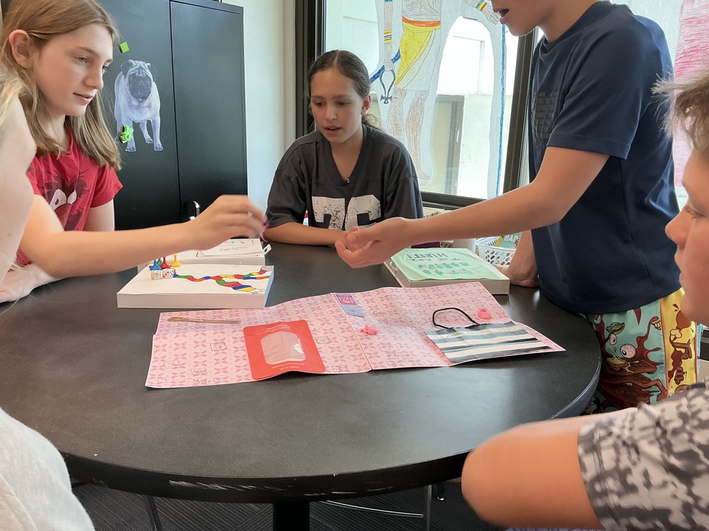 students sitting at desk playing games 