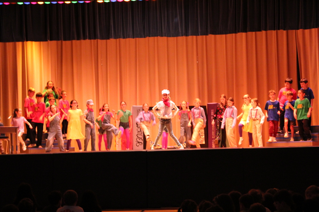 students on stage dancing 