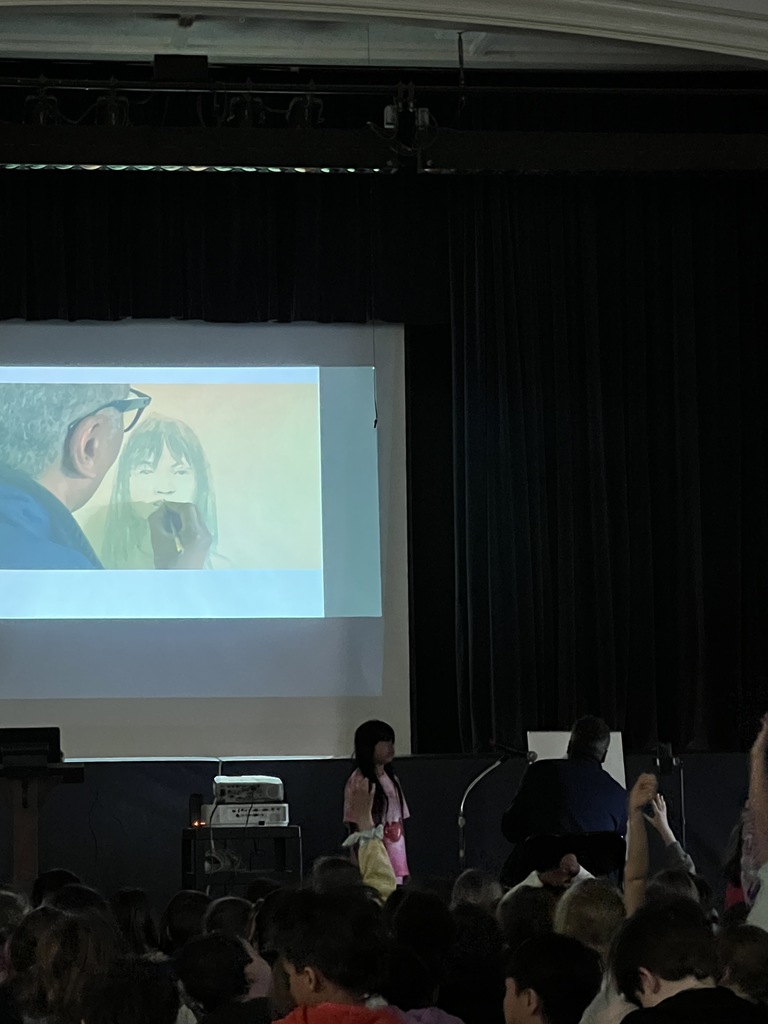 student standing author sitting sketching