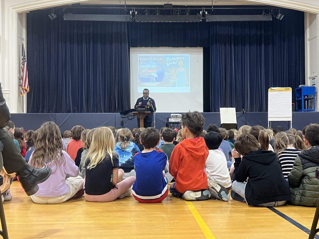 students sitting author standing