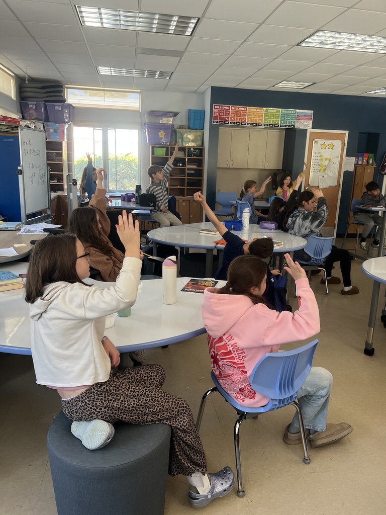 students raising hands