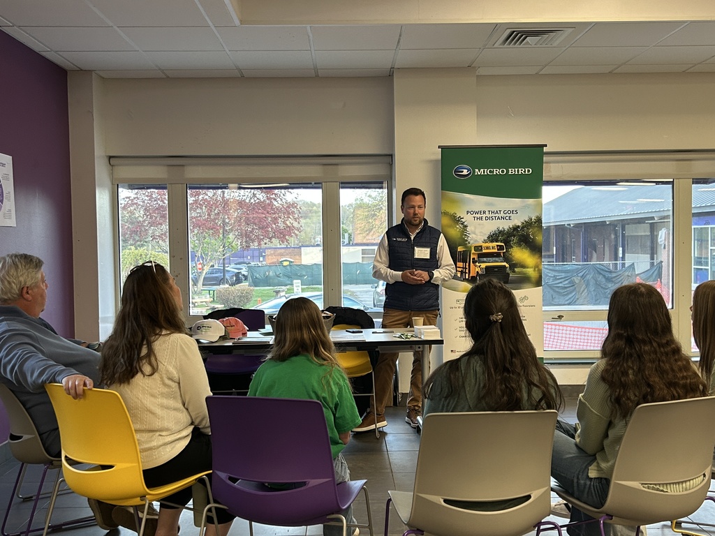 students sitting person standing talking