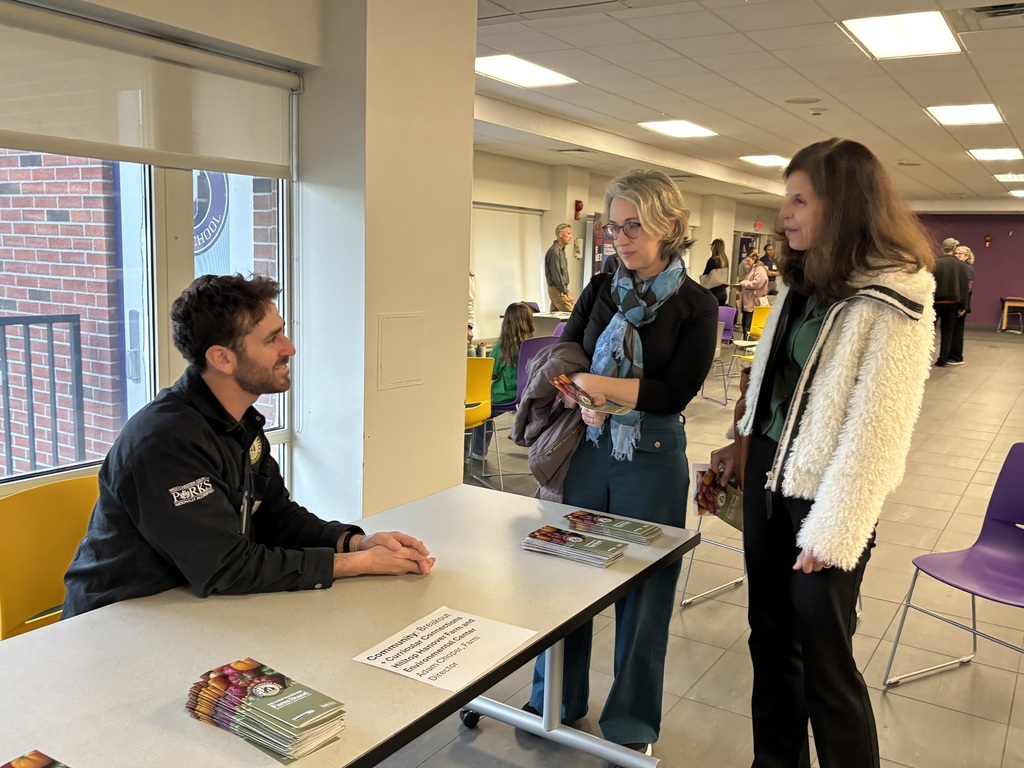 person sitting two people standing
