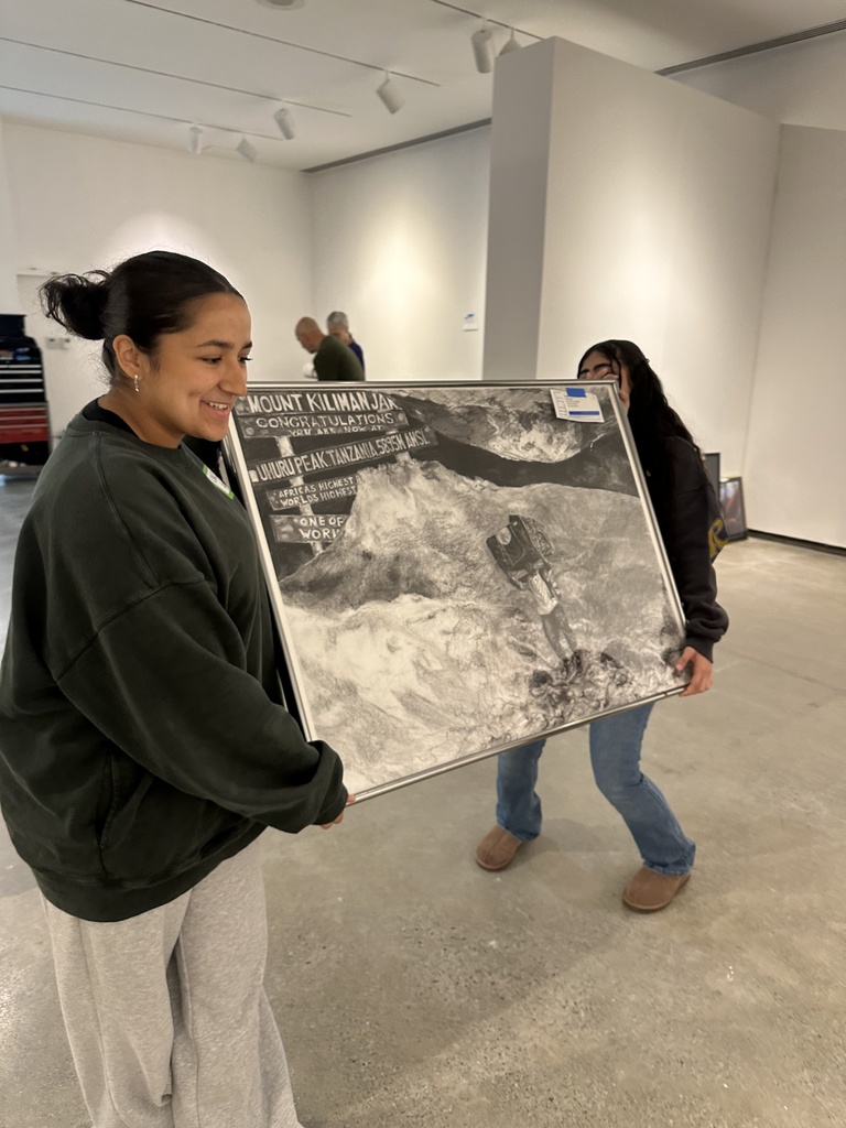 students holding artwork