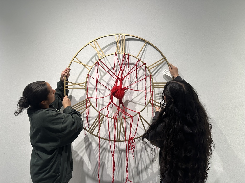 students holding artwork