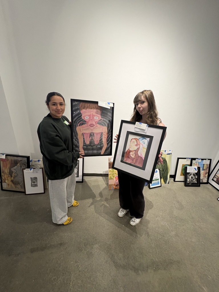students holdng artwork