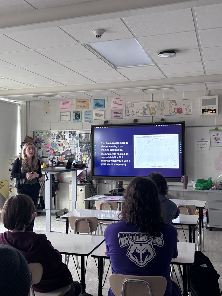students sitting adult standing talking
