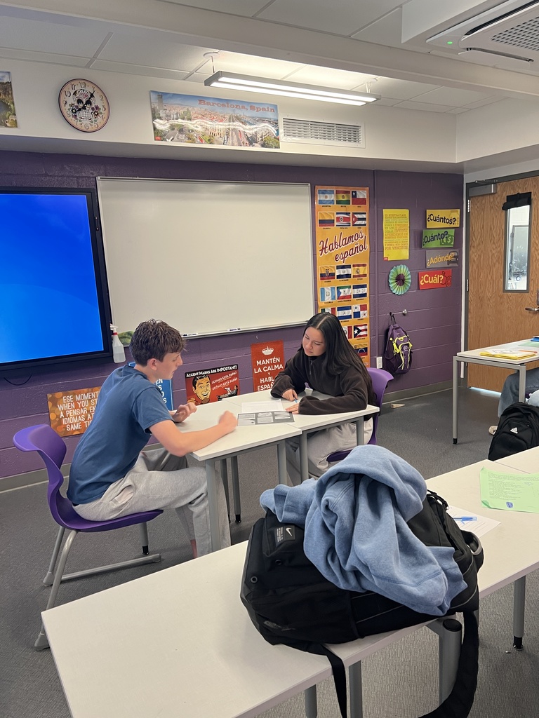 students sitting at desk talking