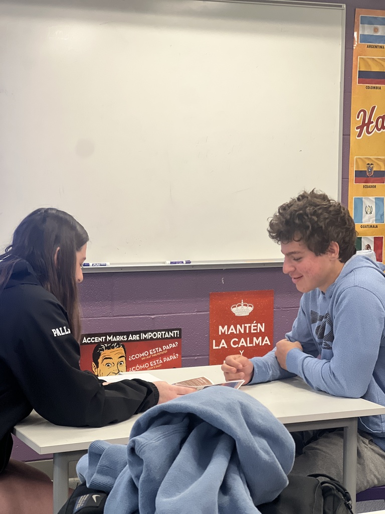 students sitting at desk talking