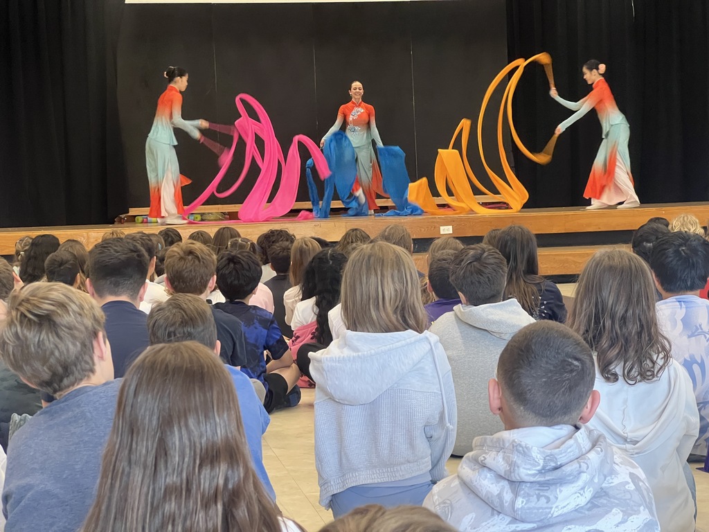 dancers on stage students sitting watching