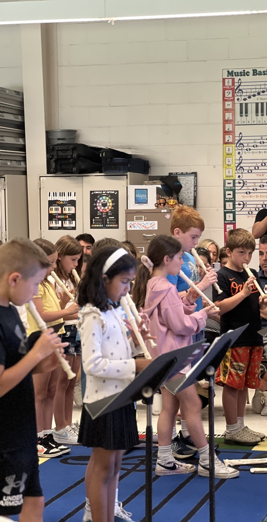 students standing playing instruments