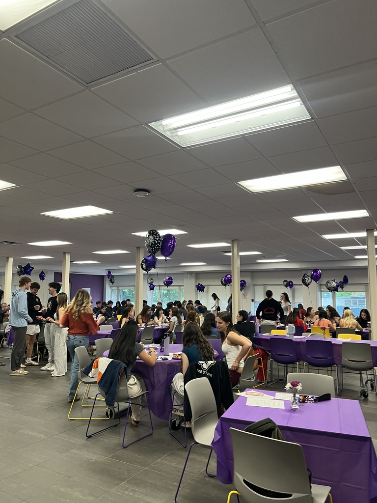 students standing and sitting at tables