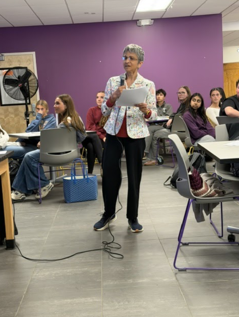 students sitting speaker standing
