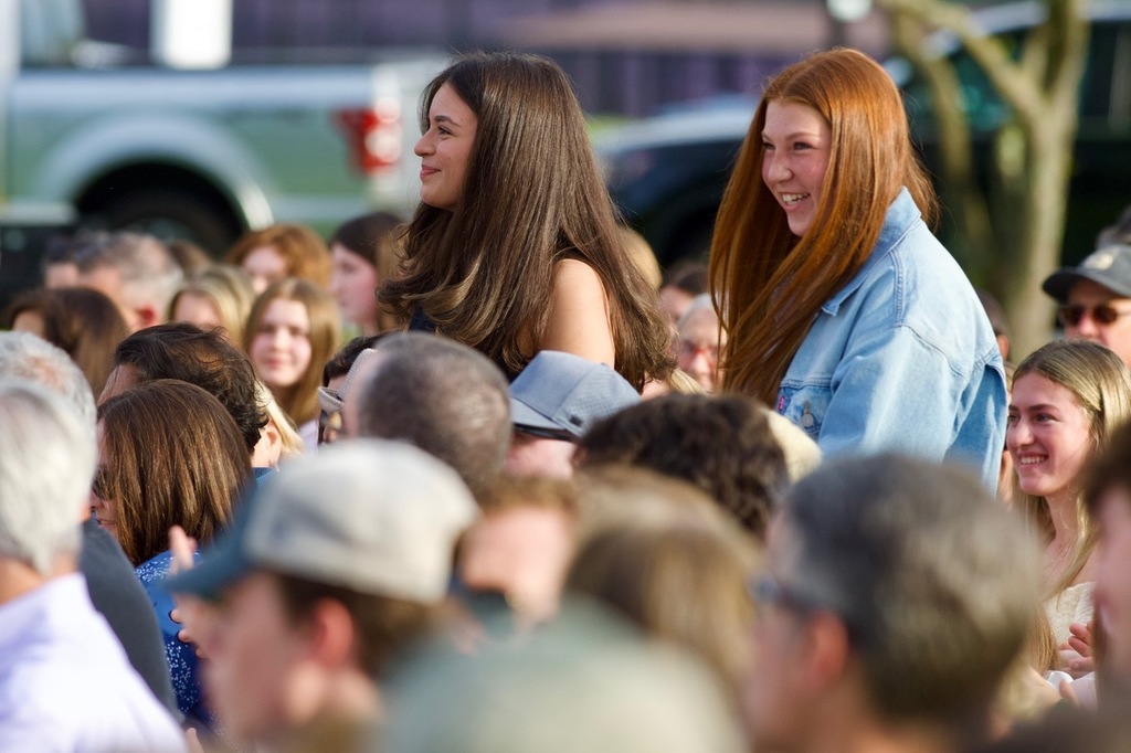 students standing adults sitting