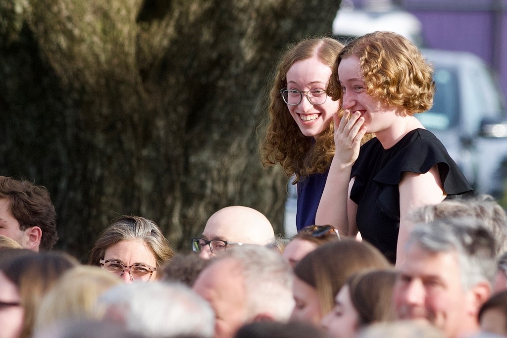 students standing adults sitting