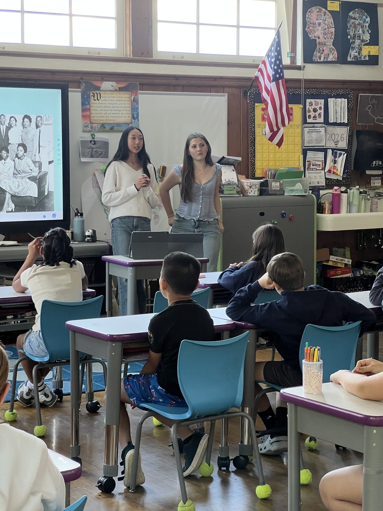 students standing and students sitting at desks