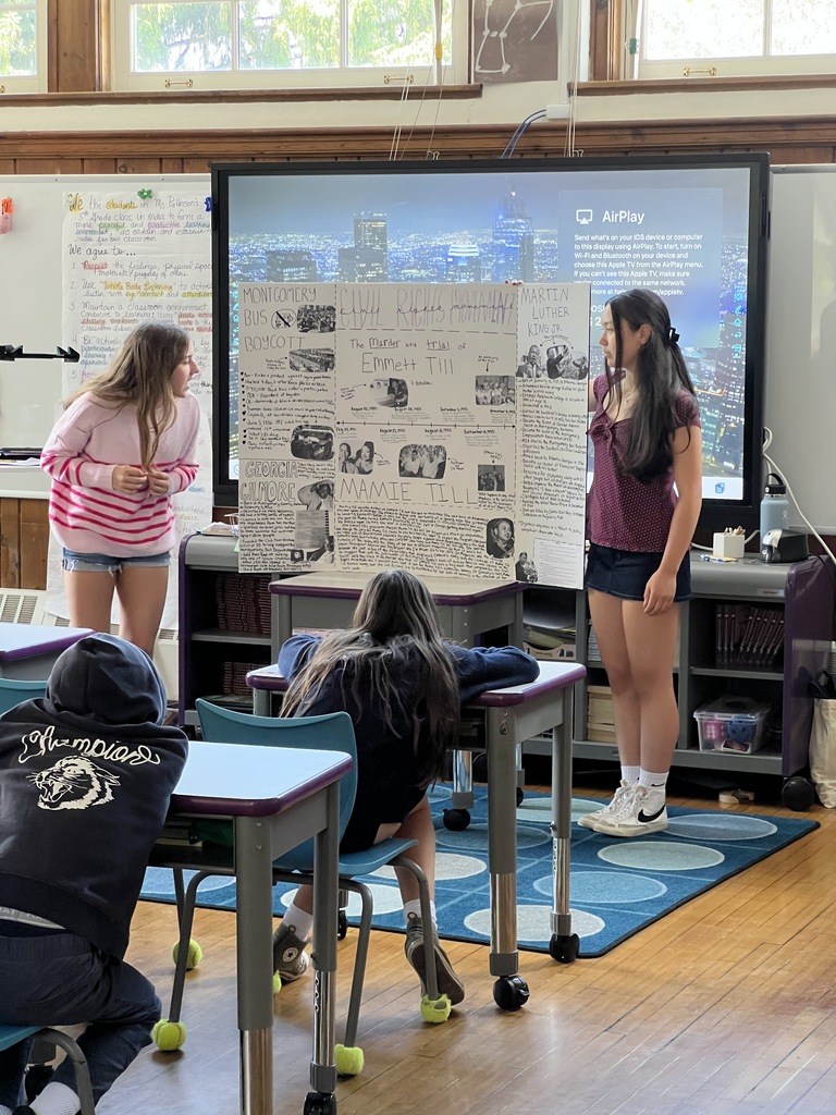 students standing presenting and students sitting