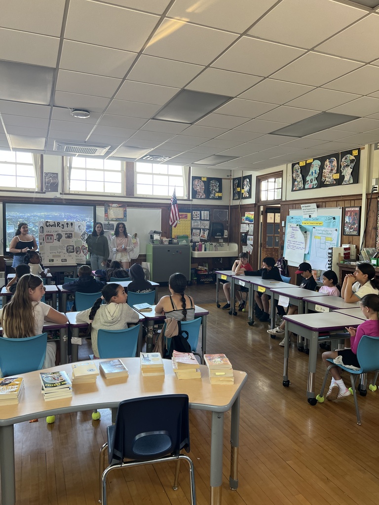 students standing and students sitting at desks