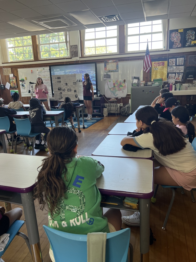 students standing and students sitting at desks