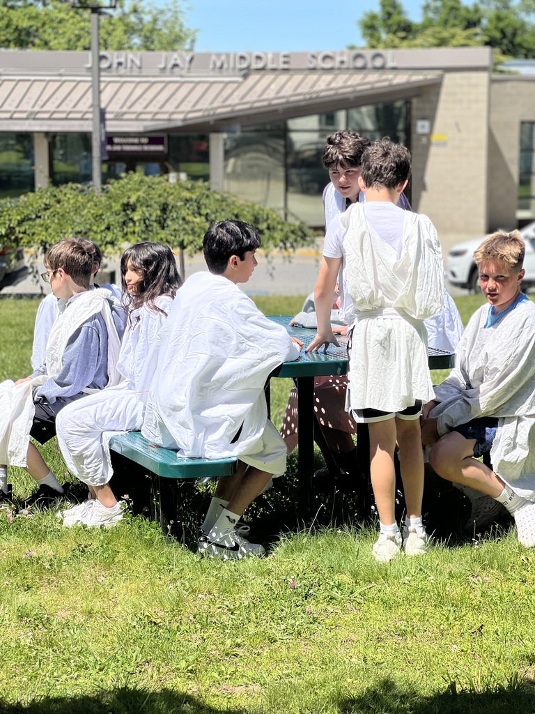 students standing and sitting outside