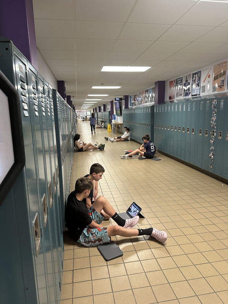 students sitting in hallway
