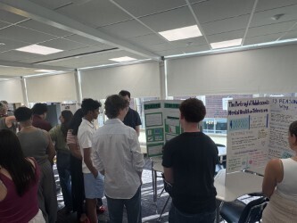 students standing with posters