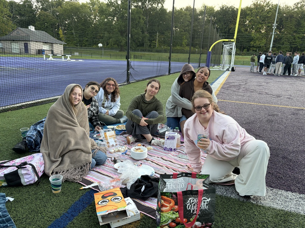 students sitting on field