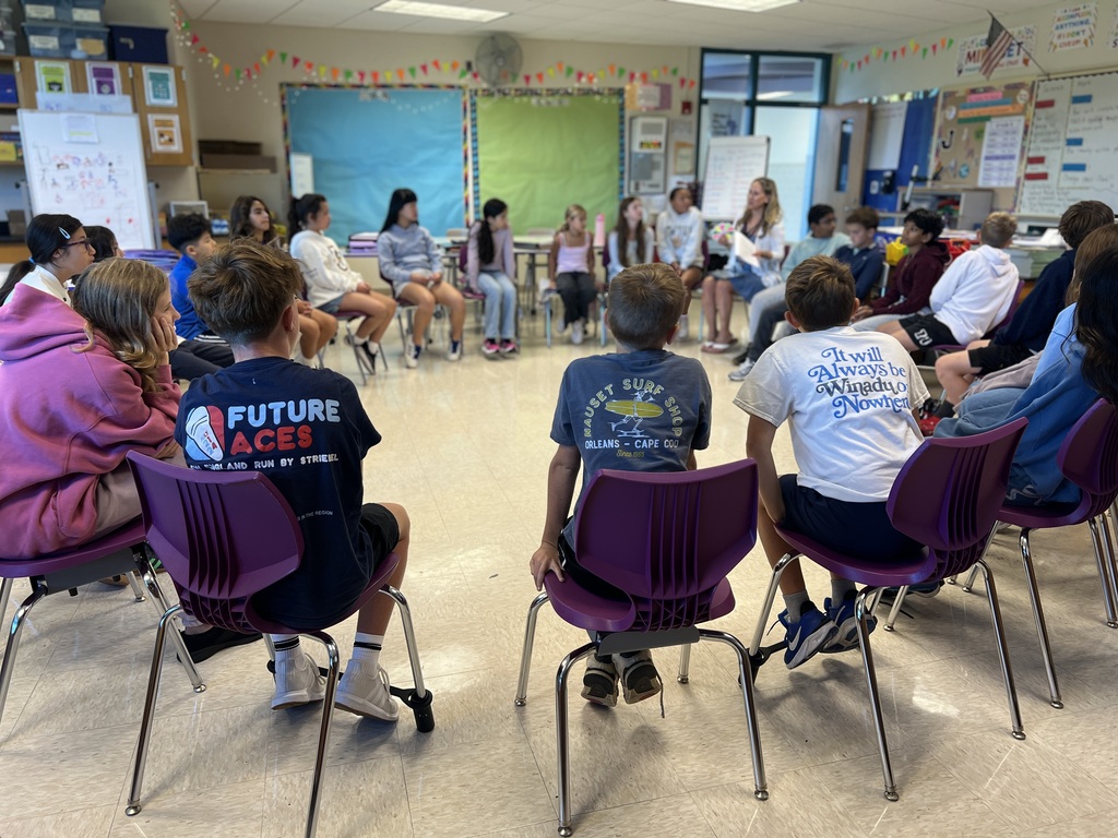 students sitting in a circle on chairs