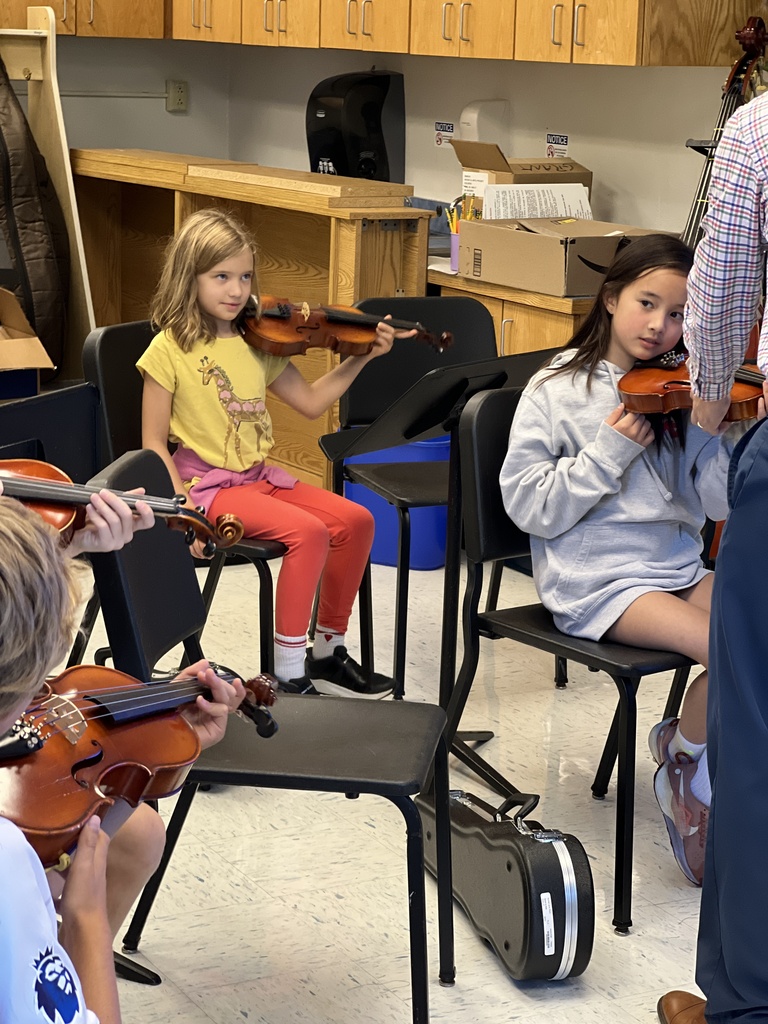 students sitting with their violas