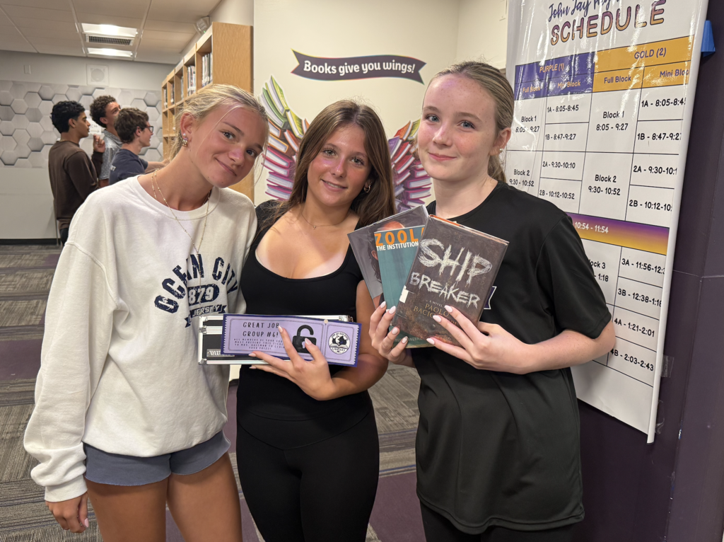students standing holding books