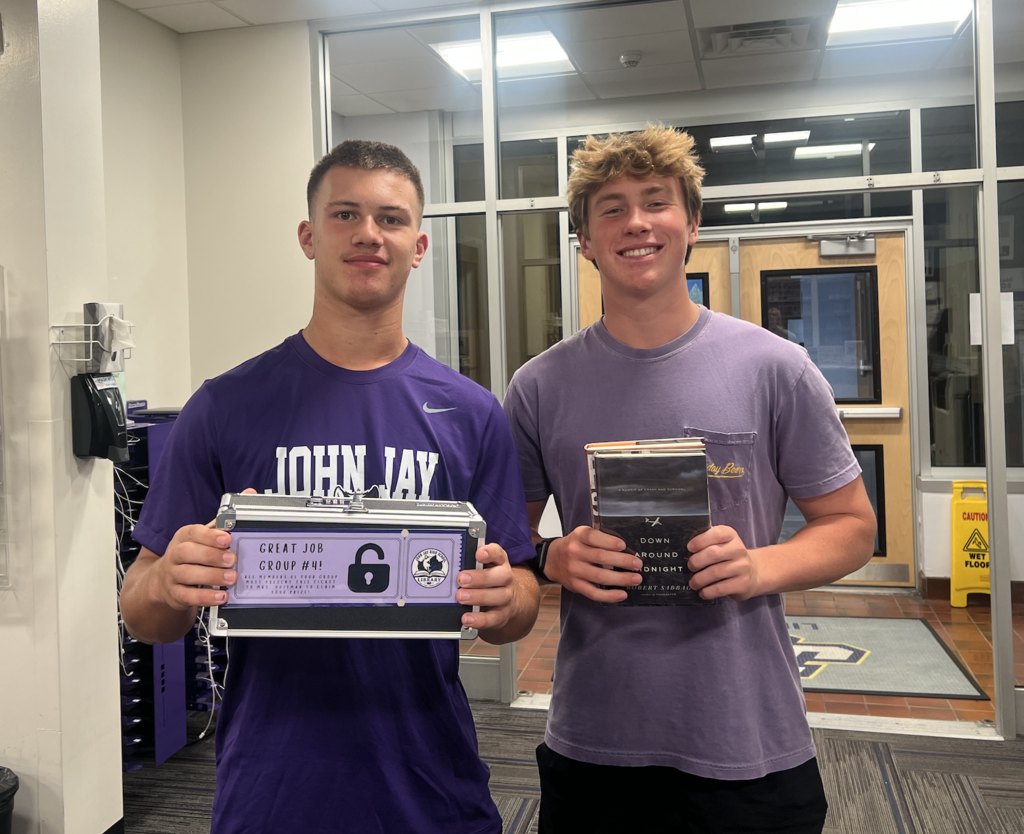 students standing holding books