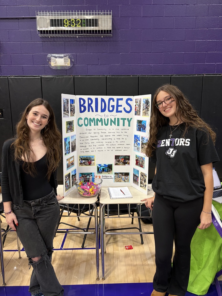 students standing by posters