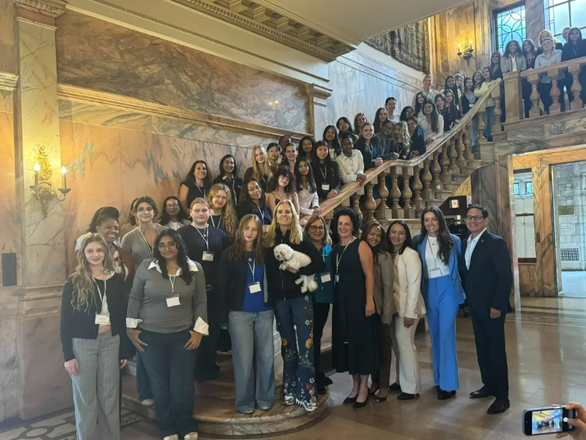 students and adults standing on staircase