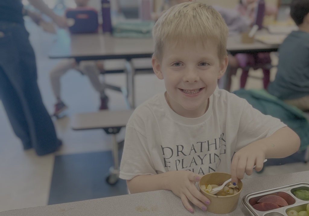 student eating soup