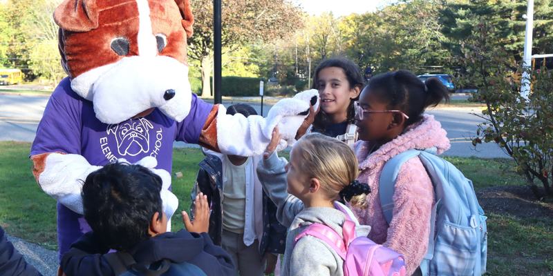 Buddy greets students