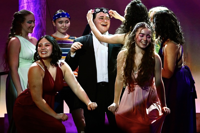 students on stage laughing