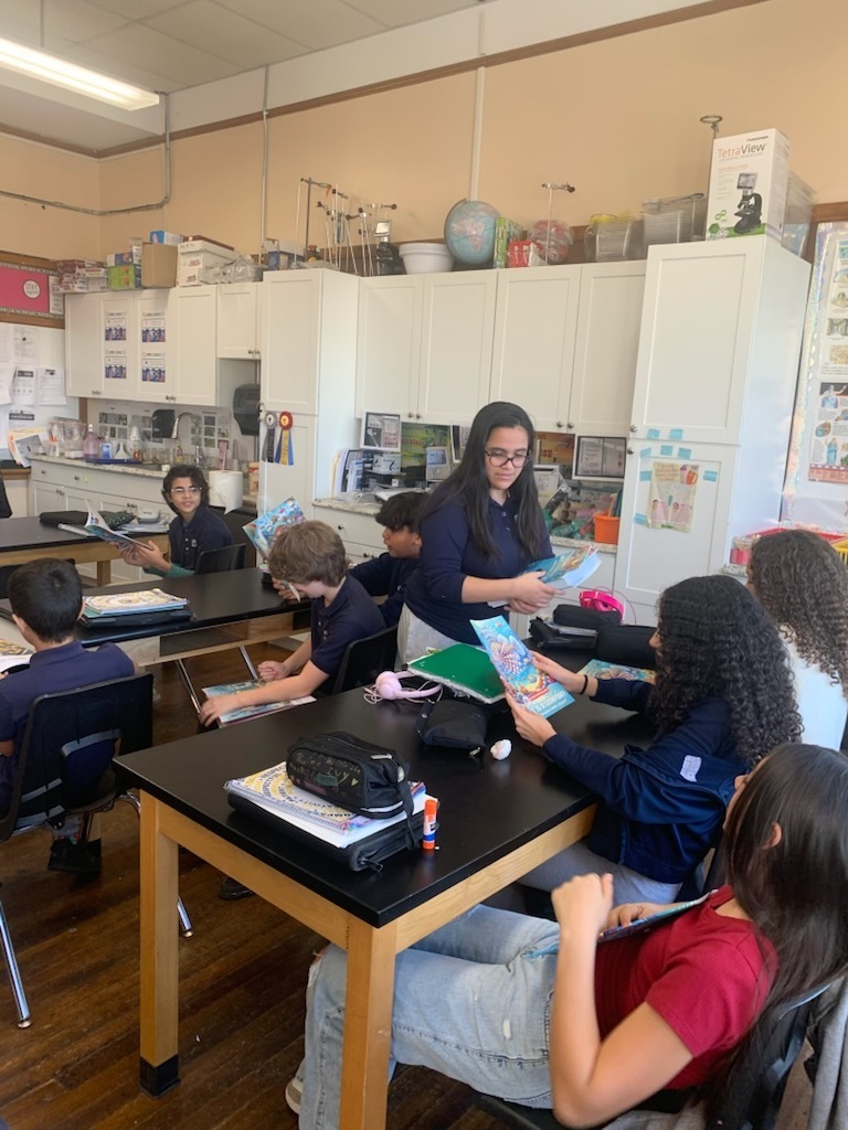 Distributing books to 6th graders