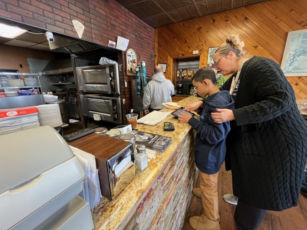 Using communication devices at Big Nicks to order Lunch