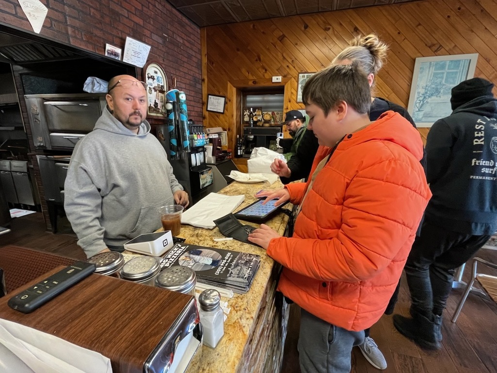 Using communication devices at Big Nicks to order Lunch