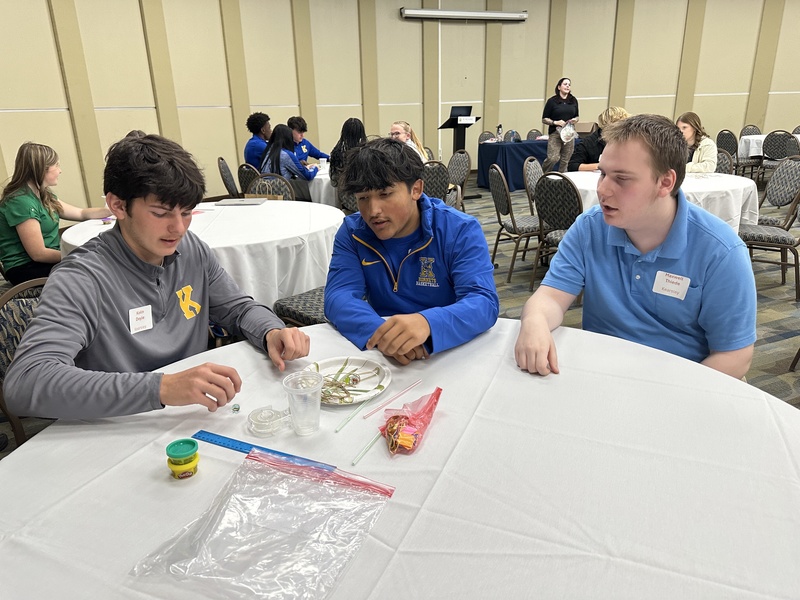cadets gathered around table
