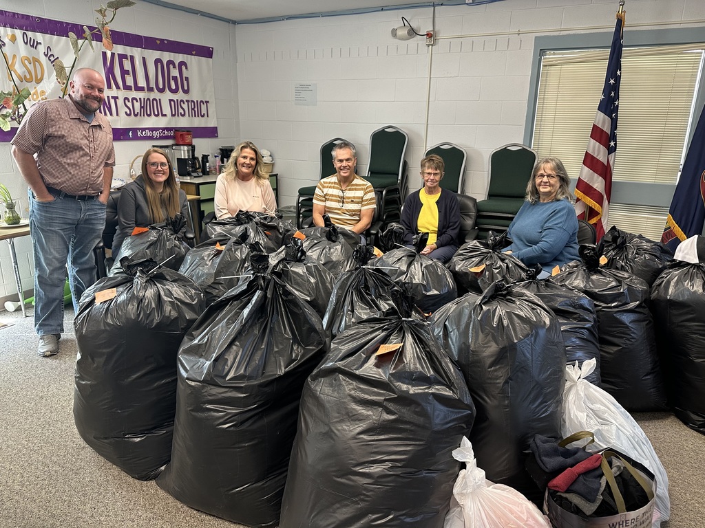 people posing with bags of coats