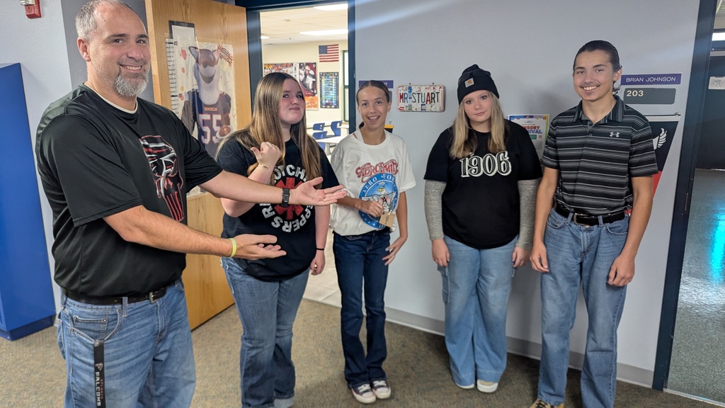 Mr. Stuart proudly showing off the 4 students who dressed up as him for HOCO theme day.