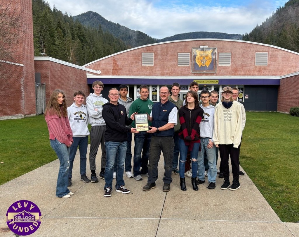 team of students posing with an award