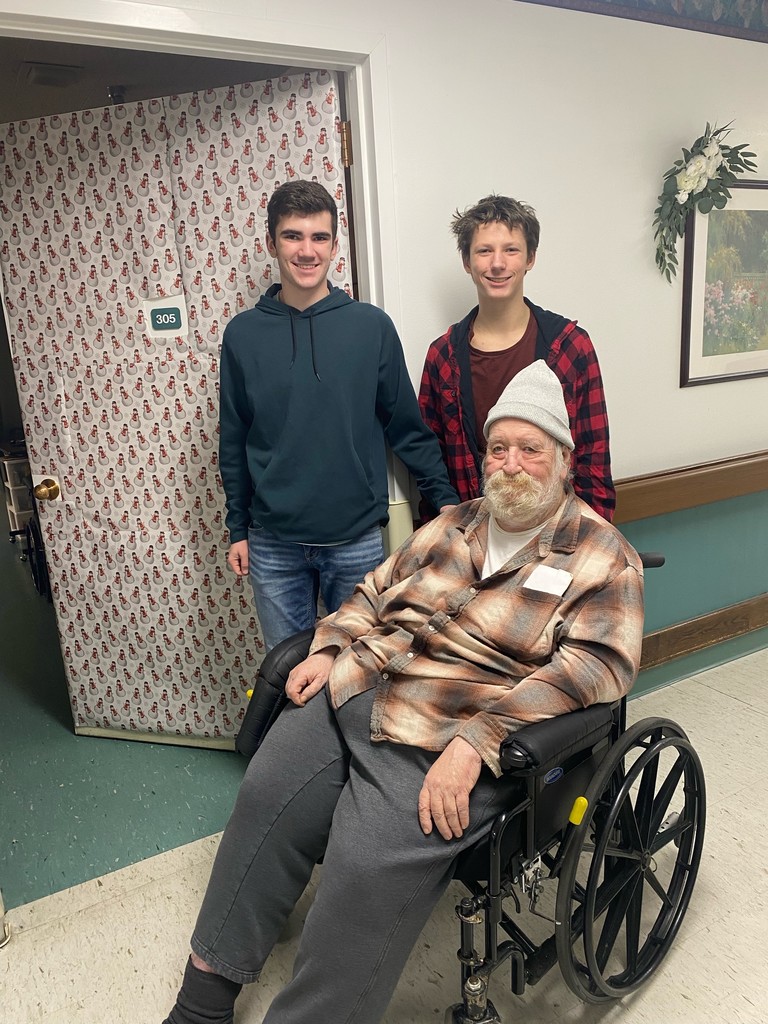 students and a resident posing with a decorated door