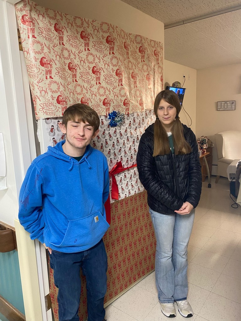 students posing with a decorated door