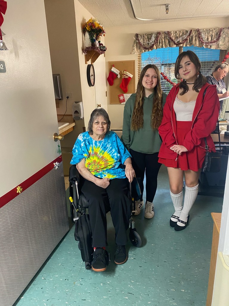 students and a resident posing with a decorated door