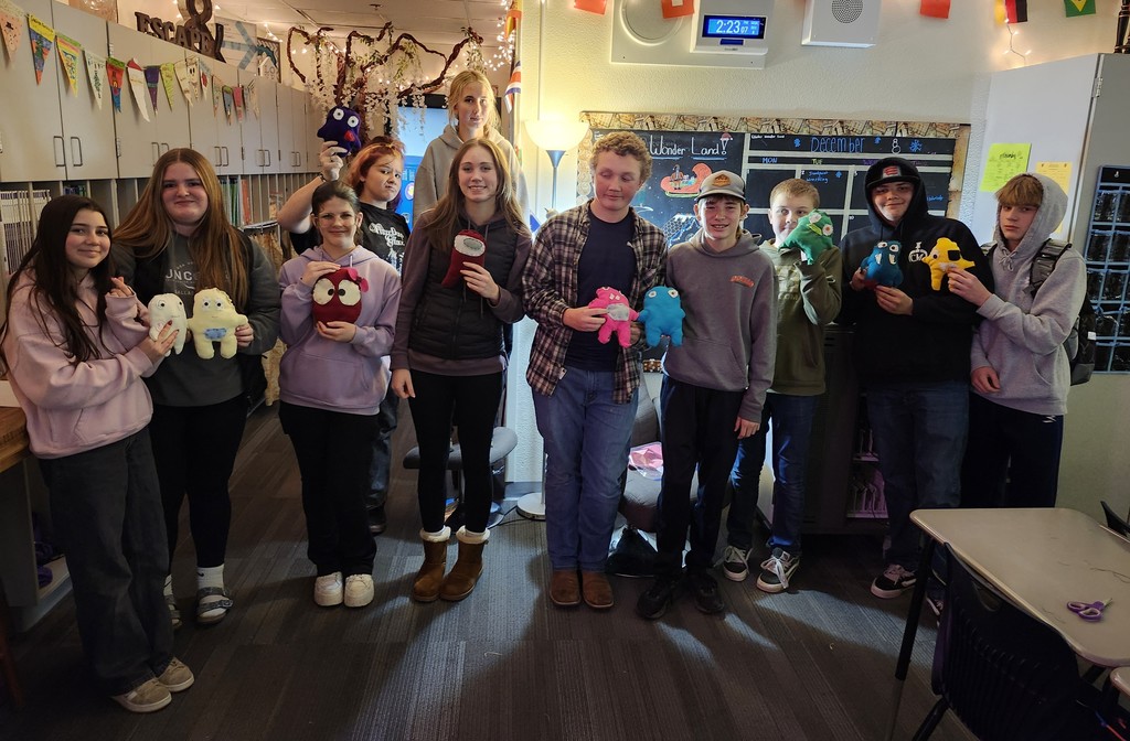 pictures of students holding their sewn designs.