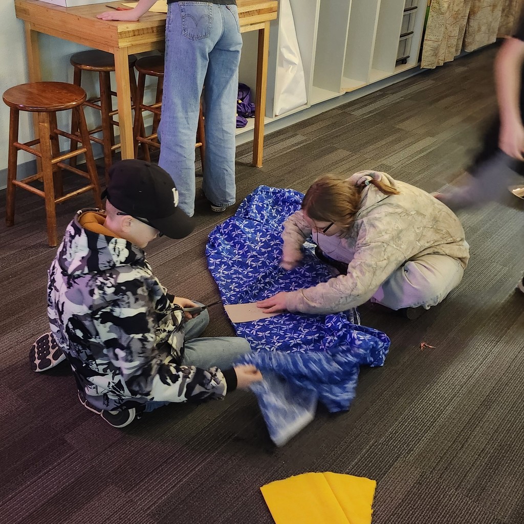 pictures of students holding their sewn designs.