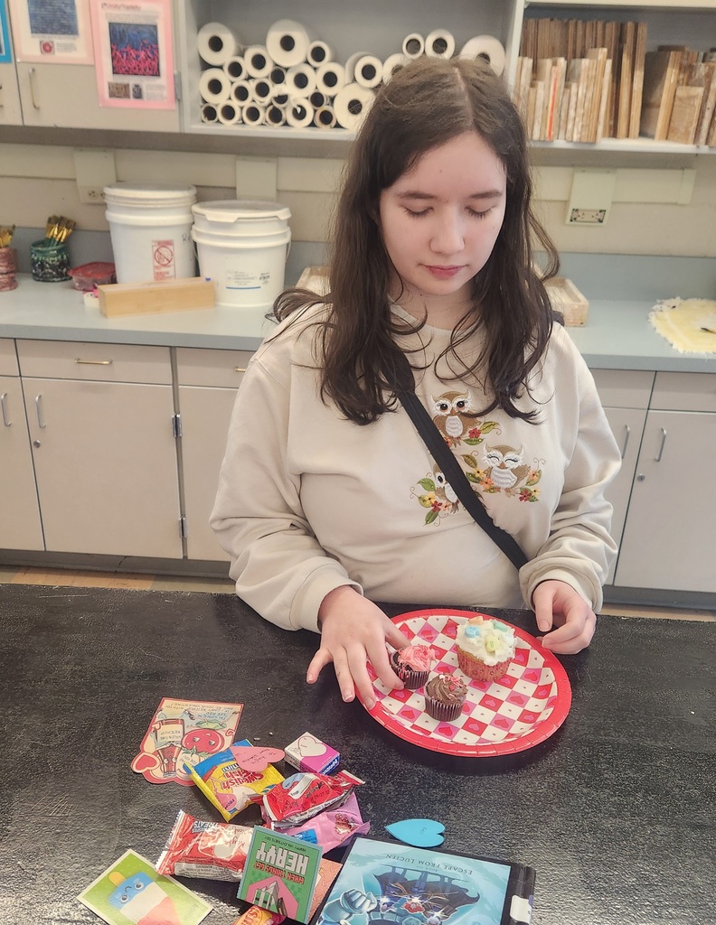 student preparing a plate of cupcakes