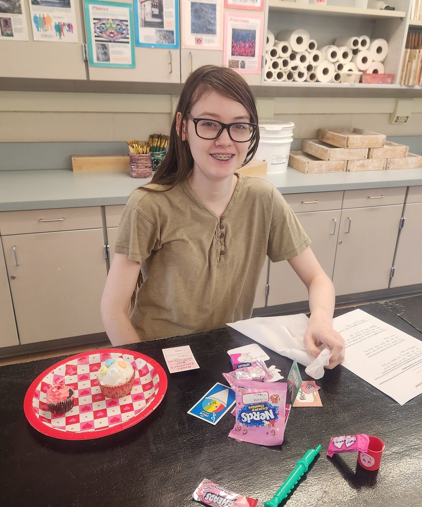 student with treats and valentine's day cards